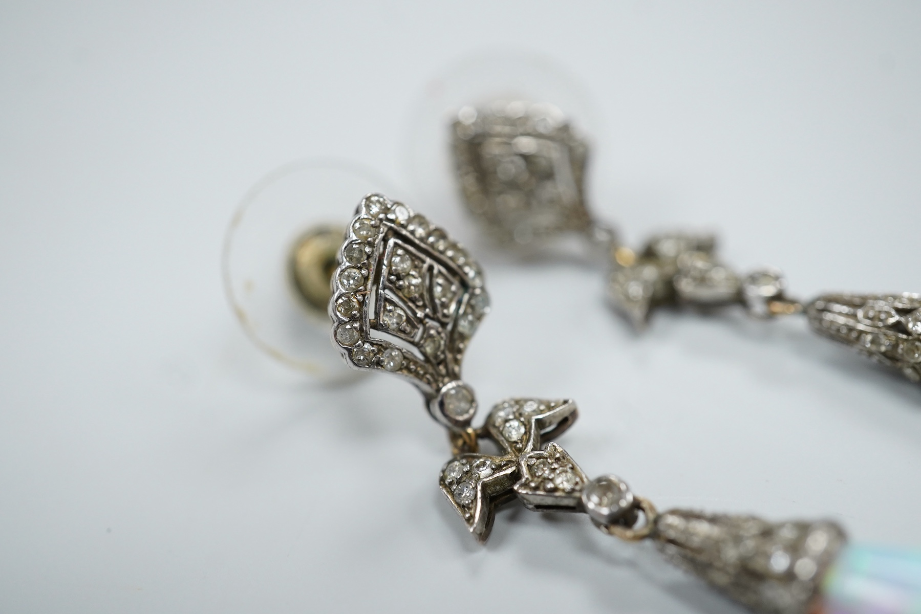 A pair of 1920's style white metal, synthetic opal and diamond chip set drop earrings, 63mm, gross weight 8.2 grams.